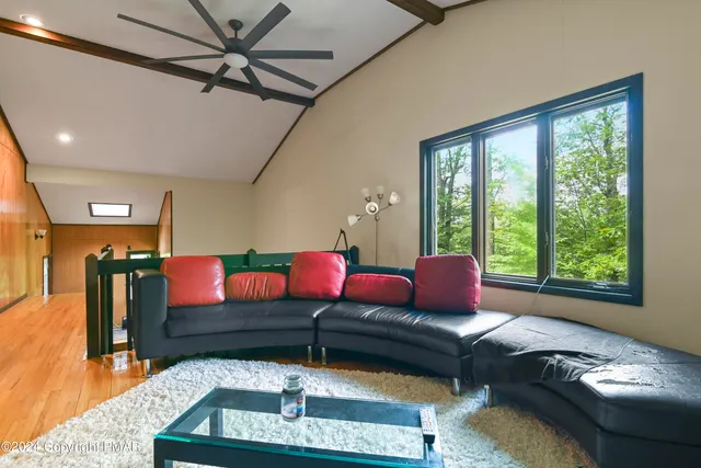 a living room with furniture and a floor to ceiling window