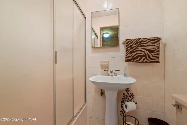 a bathroom with a sink a mirror and a toilet