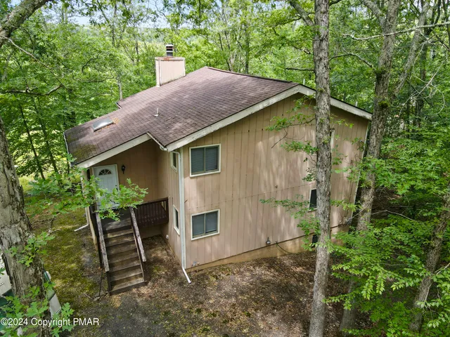 a backyard of a house with table and chairs