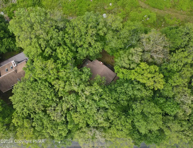 a backyard of a house with lots of green space and a fountain
