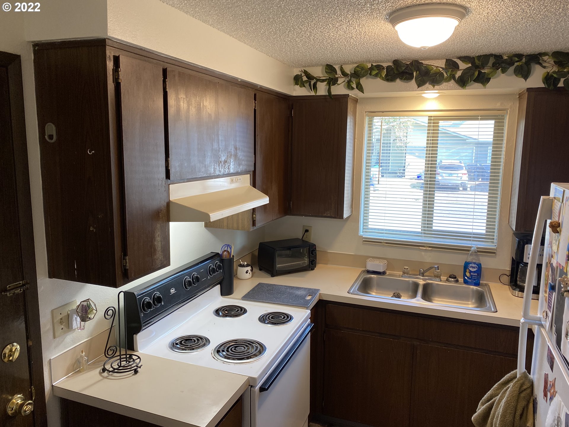 85 V Street Springfield, OR 97477 - Photo 3 of 25 a kitchen with a sink a stove and a refrigerator