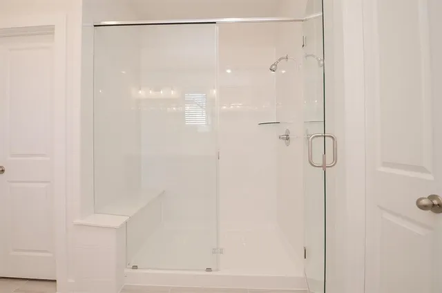 a bathroom with a glass shower door