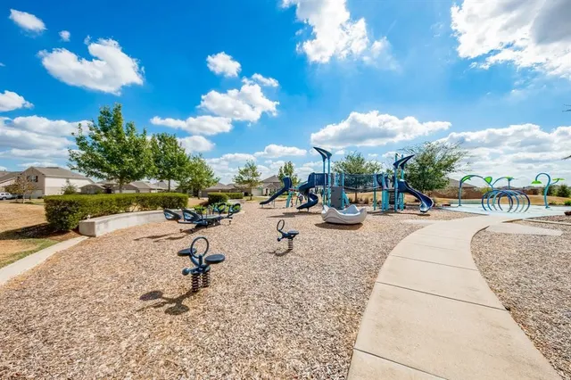 a view of a park with swings and slides