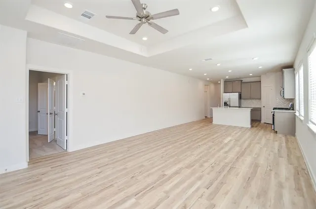 a view of a kitchen with a sink and a refrigerator