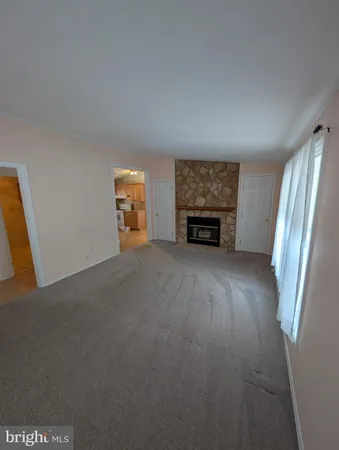 a view of an empty room with a fireplace