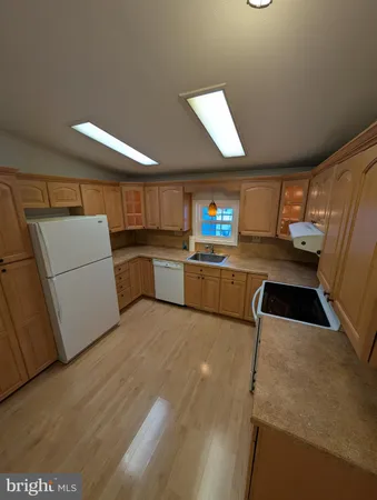 a kitchen with a refrigerator and a stove top oven