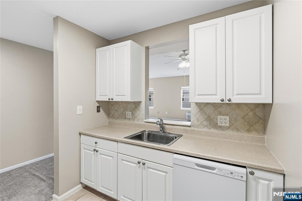 905 River Road, Unit 204 Edgewater, NJ 07020 - Photo 15 of 36 a kitchen with stainless steel appliances granite countertop a sink and a white cabinets