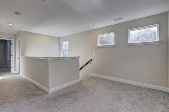 an entryway and hallway with washer and dryer