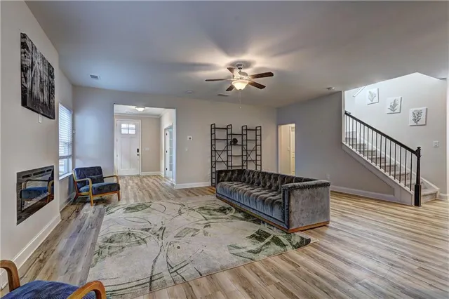 a dining room with furniture a chandelier and wooden floor