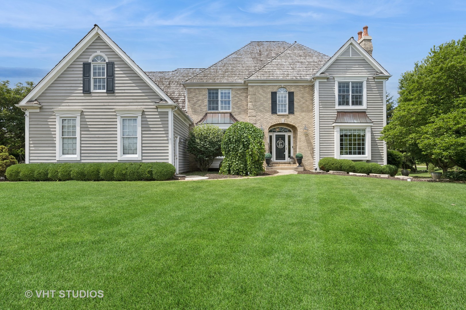 a front view of a house with a yard