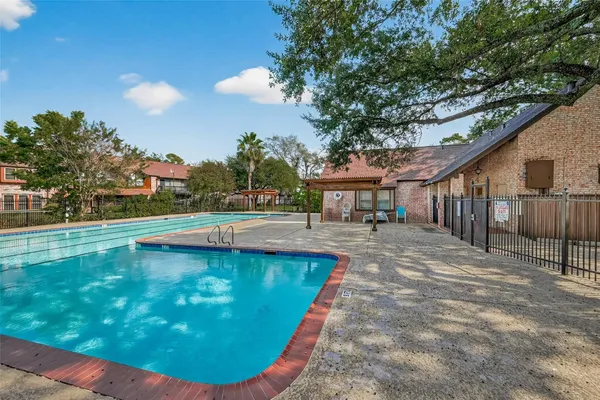 a view of a swimming pool with a patio