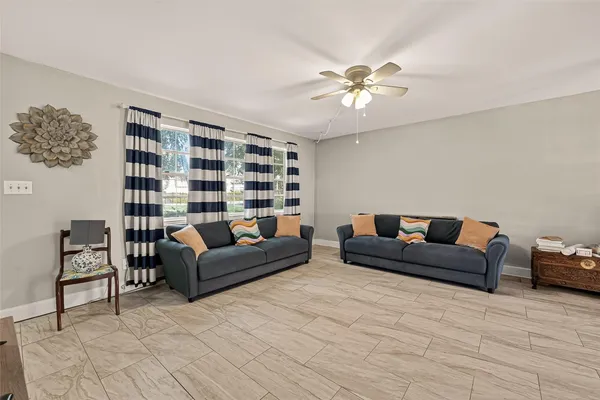 a living room with furniture and a chandelier