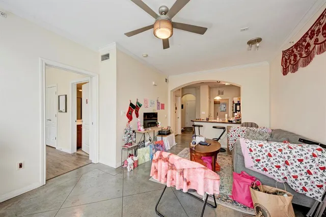 a living room with furniture and a chandelier