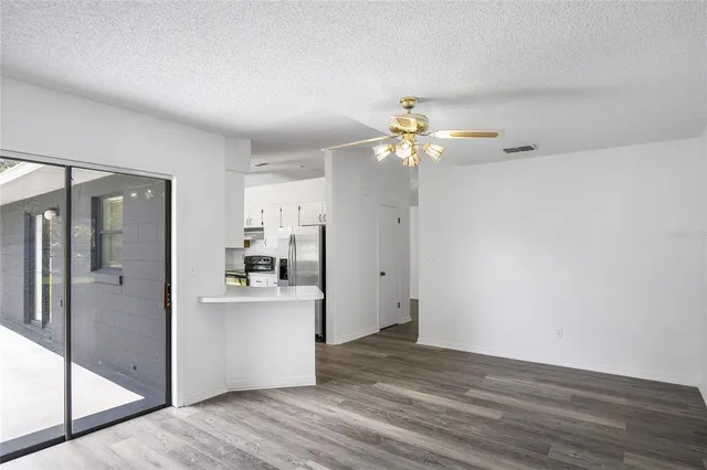 a view of a kitchen with a white cabinet and a stove top oven