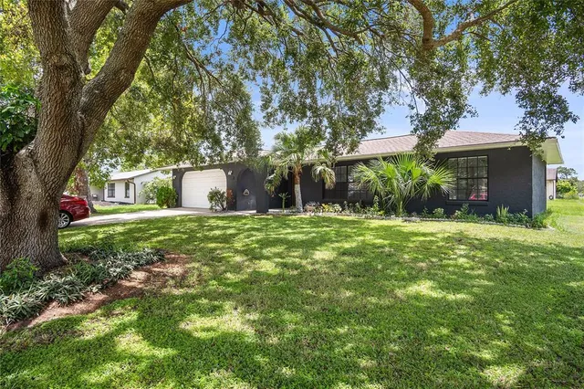 a front view of house with yard and green space
