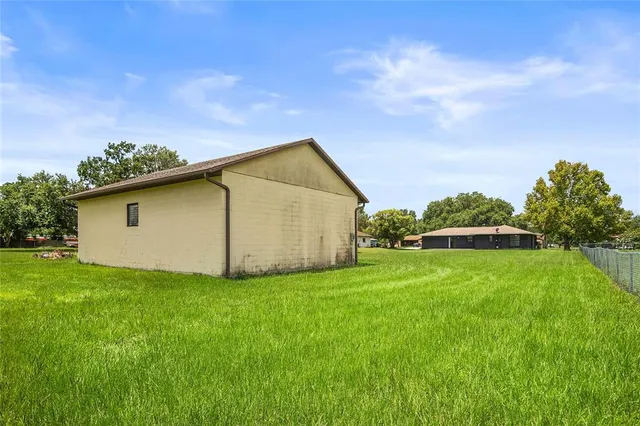 a backyard of a house with lots of green space and fountain