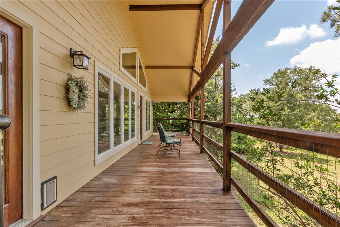 9997 Calhoun Road Bryan, TX 77808 - Photo 24 of 50 a view of balcony with wooden floor and stairs