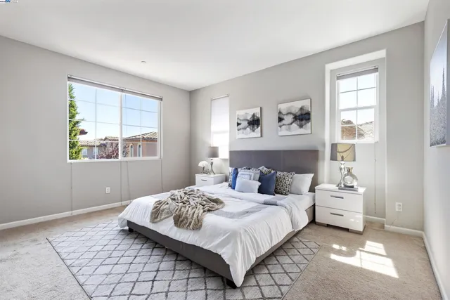 a bedroom with a large bed and a window