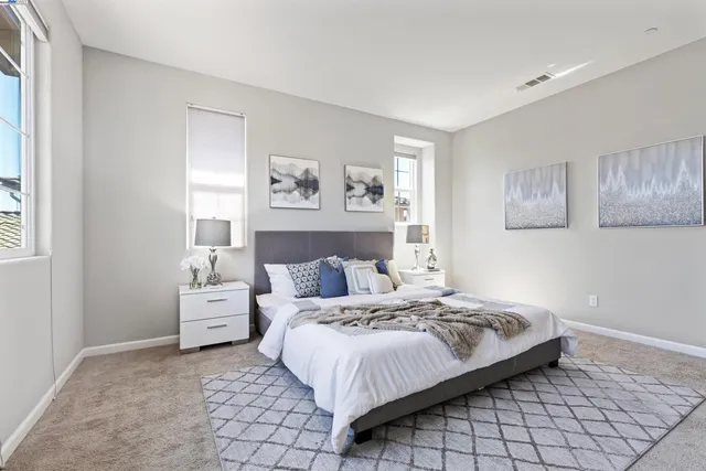 a bedroom with a bed and painting on the wall