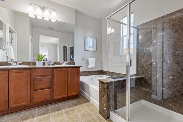 a bathroom with a sink double vanity and a mirror