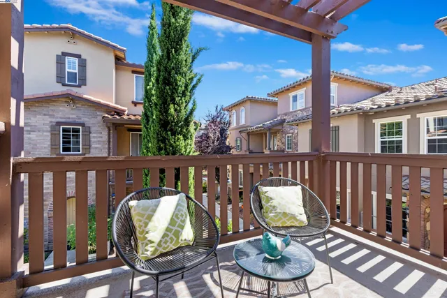 a view of a chair and tables in the balcony