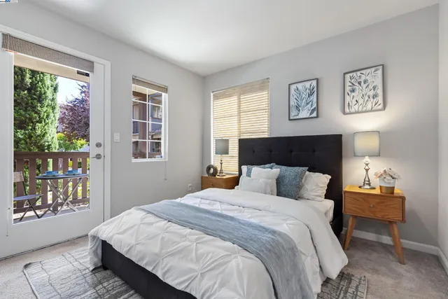 a bedroom with a large bed and a window