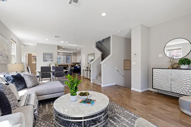 a living room with furniture and a dining table