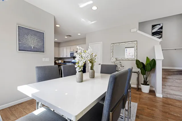 a dining room with furniture and wooden floor