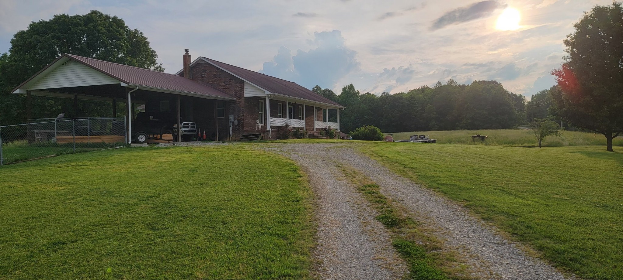 a view of a big house with a big yard and potted plants