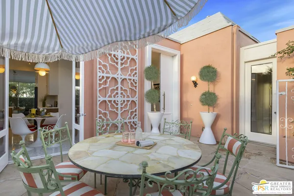a dining room with furniture and wooden floor