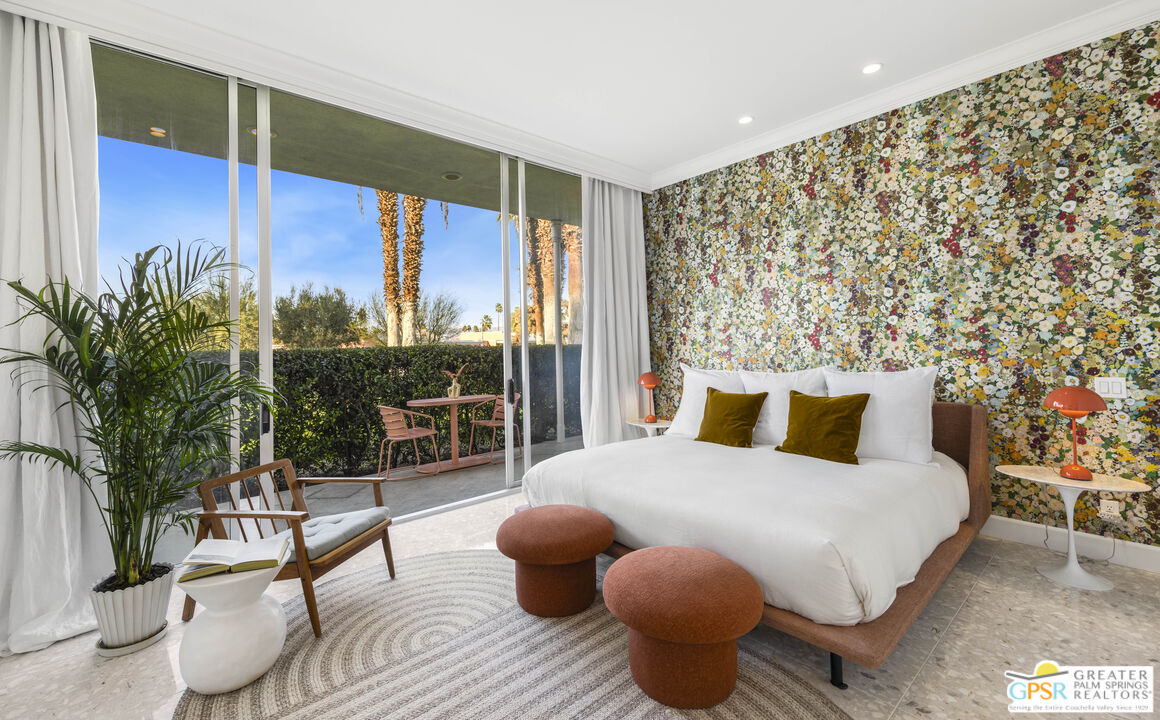 47420 Rabat Drive Palm Desert, CA 92260 - Photo 2 of 27 a bedroom with a large bed and a potted plant