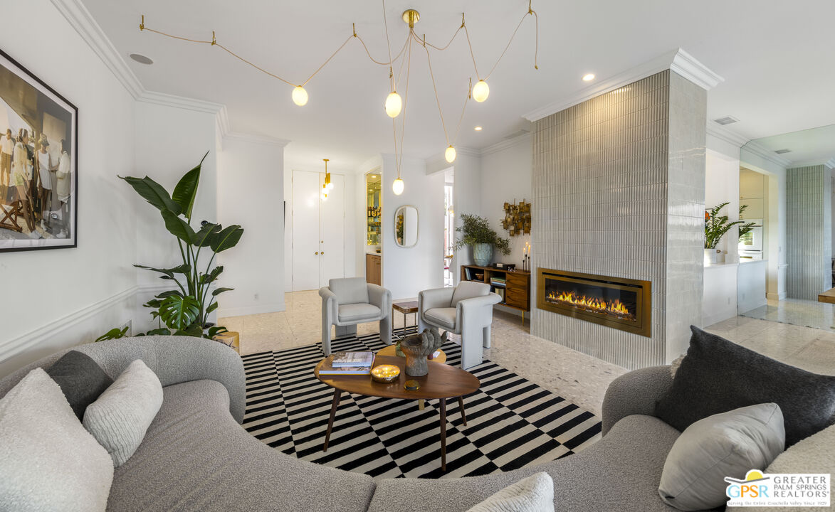 47420 Rabat Drive Palm Desert, CA 92260 - Photo 22 of 27 a living room with furniture a fireplace and a potted plant