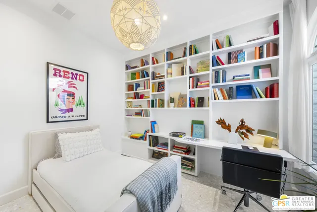 a bedroom with a bed and a book shelf