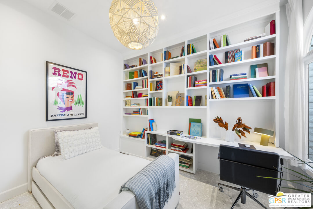 47420 Rabat Drive Palm Desert, CA 92260 - Photo 26 of 27 a bedroom with a bed and a book shelf