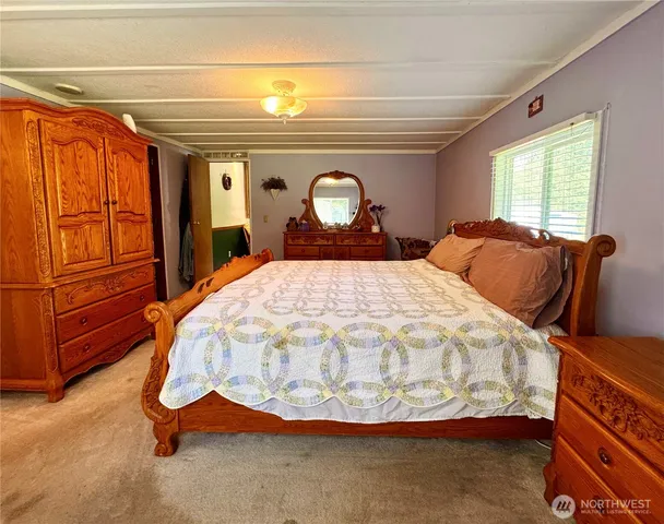 a bed sitting in a bedroom next to a window