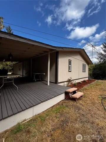 a view of a house with backyard and sitting area