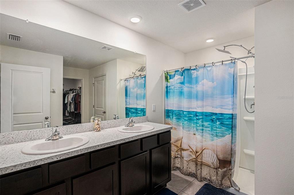 4992 North Fairways Ridge Point Beverly Hills, FL 34465 - Photo 7 of 14 a bathroom with a double vanity sink mirror and shower