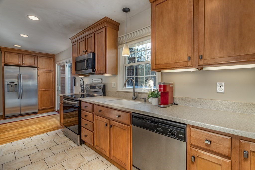 8 Brown Road Shirley, MA 01464 - Photo 15 of 42 a kitchen with stainless steel appliances granite countertop a sink and a refrigerator