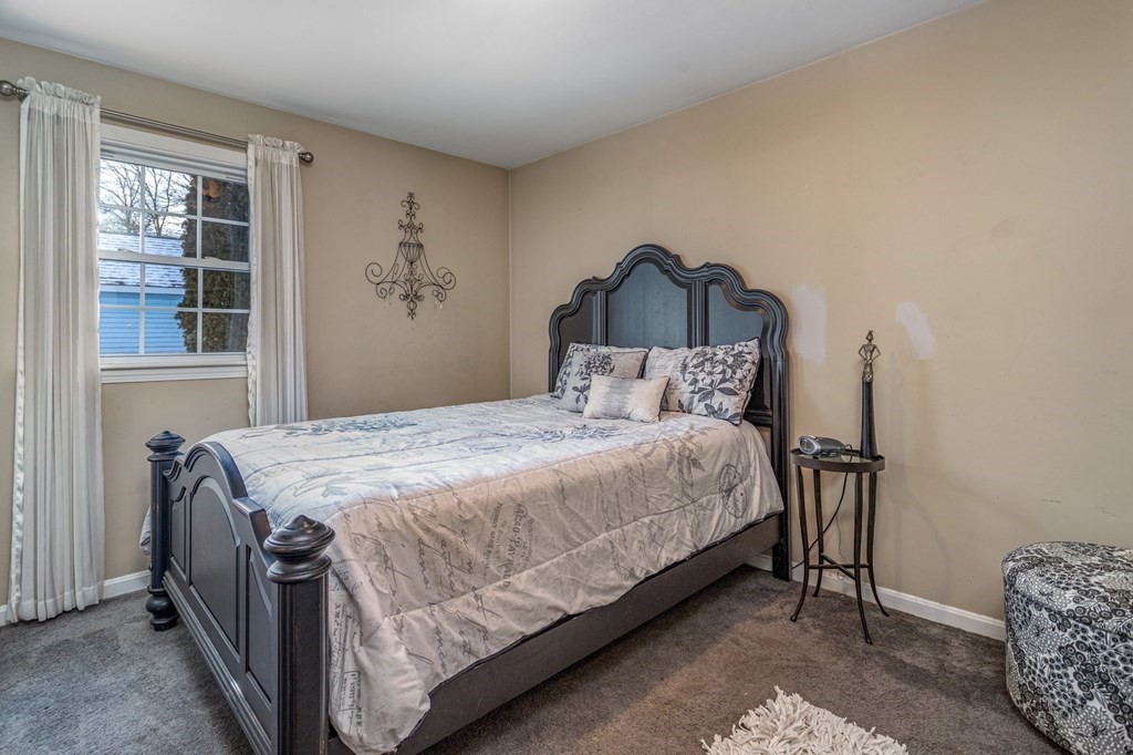 8 Brown Road Shirley, MA 01464 - Photo 20 of 42 a bedroom with a bed and a dresser next to a window