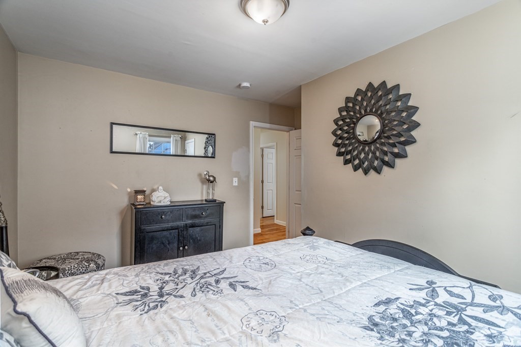 8 Brown Road Shirley, MA 01464 - Photo 23 of 42 a bedroom with a bed and a chandelier