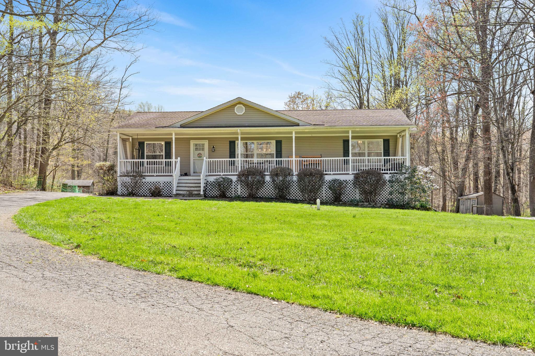 a front view of a house with a garden and yard