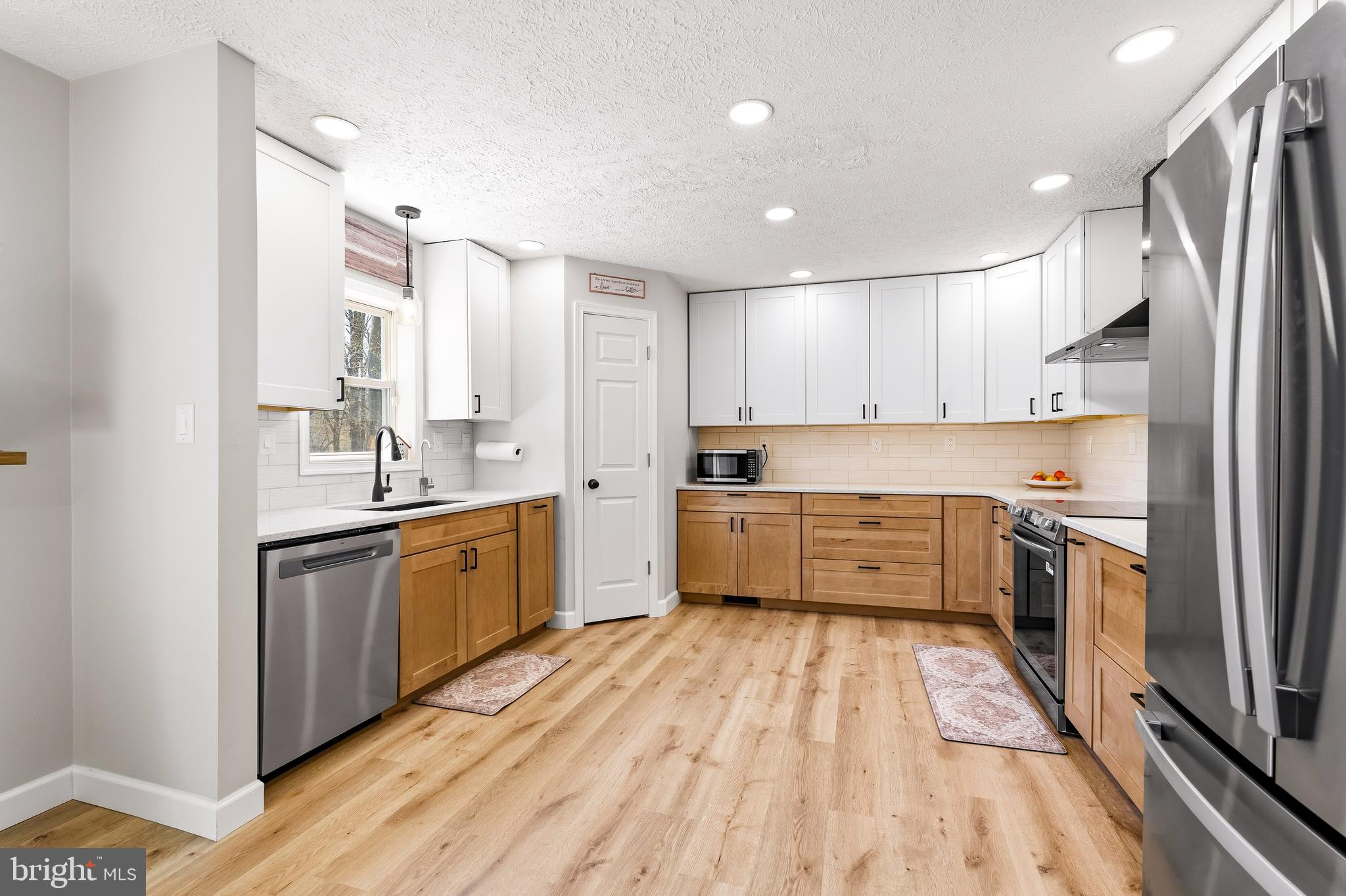 458 Tonys Road Elkton, MD 21921 - Photo 13 of 27 a kitchen with stainless steel appliances a sink cabinets and wooden floor