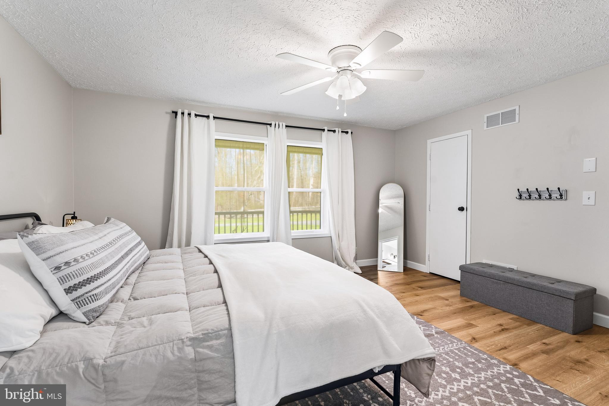 458 Tonys Road Elkton, MD 21921 - Photo 23 of 27 a bedroom with a bed next to a window with workspace