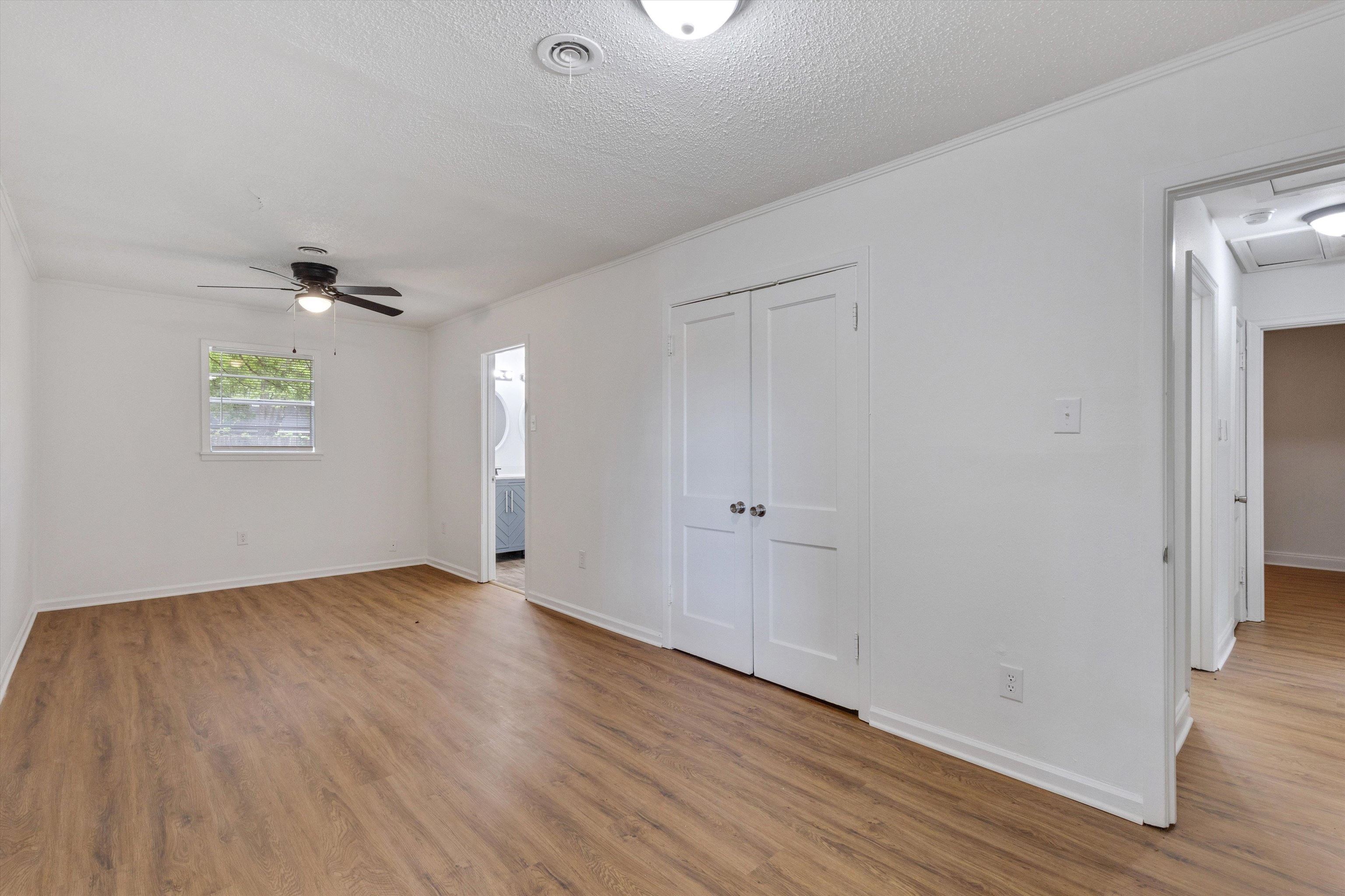 4565 Verne Road Memphis, TN 38117 - Photo 11 of 18 Spacious room with wood-finish flooring, white walls, and a ceiling fan