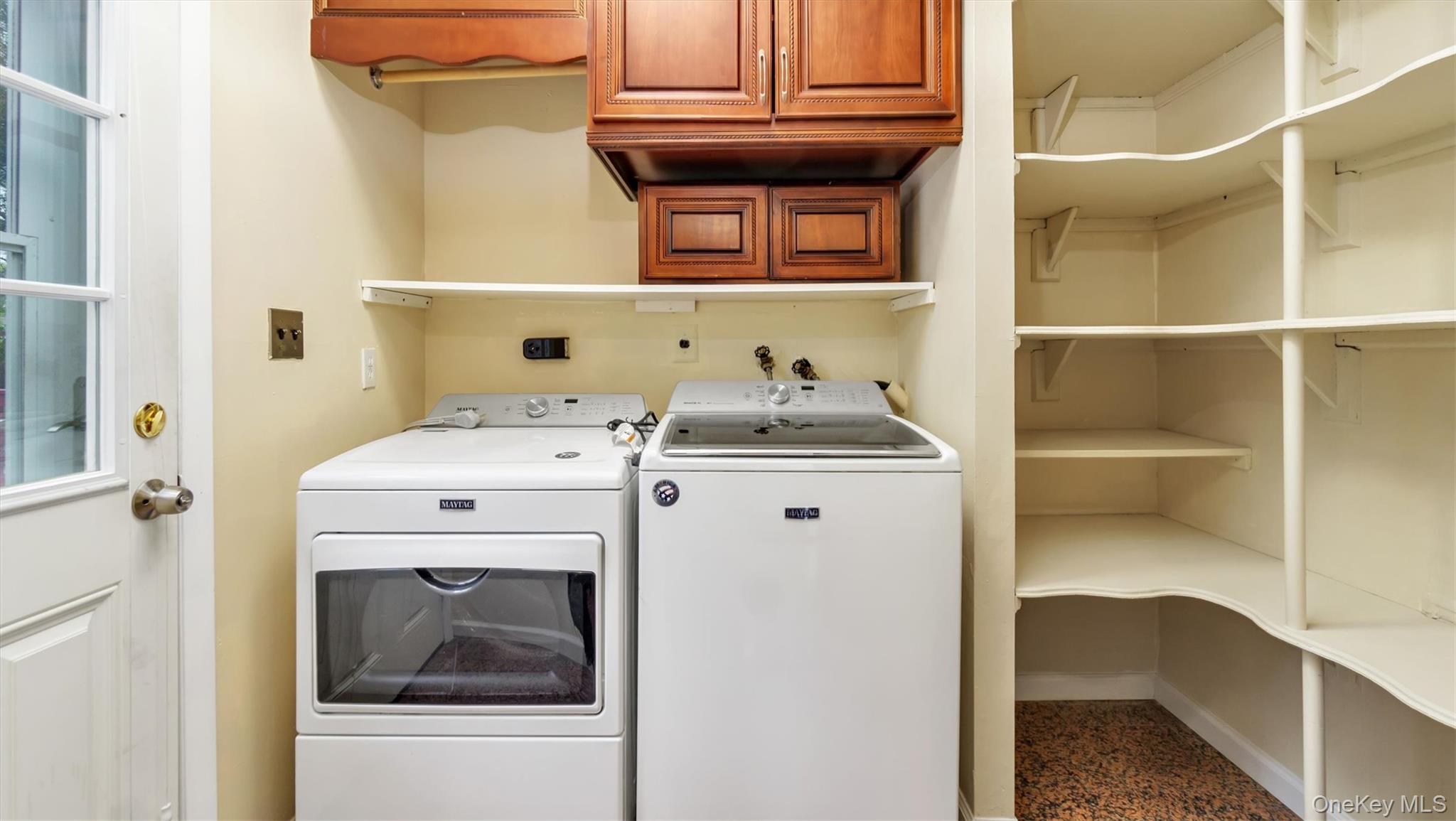 47 Carriage Road Roslyn, NY 11576 - Photo 14 of 31 Washroom with washing machine and clothes dryer, cabinet space, and baseboards