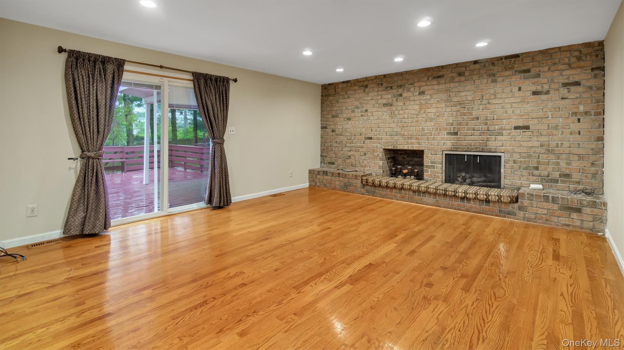47 Carriage Road Roslyn, NY 11576 - Photo 16 of 31 Unfurnished living room with light wood-style flooring, baseboards, visible vents, and recessed lighting