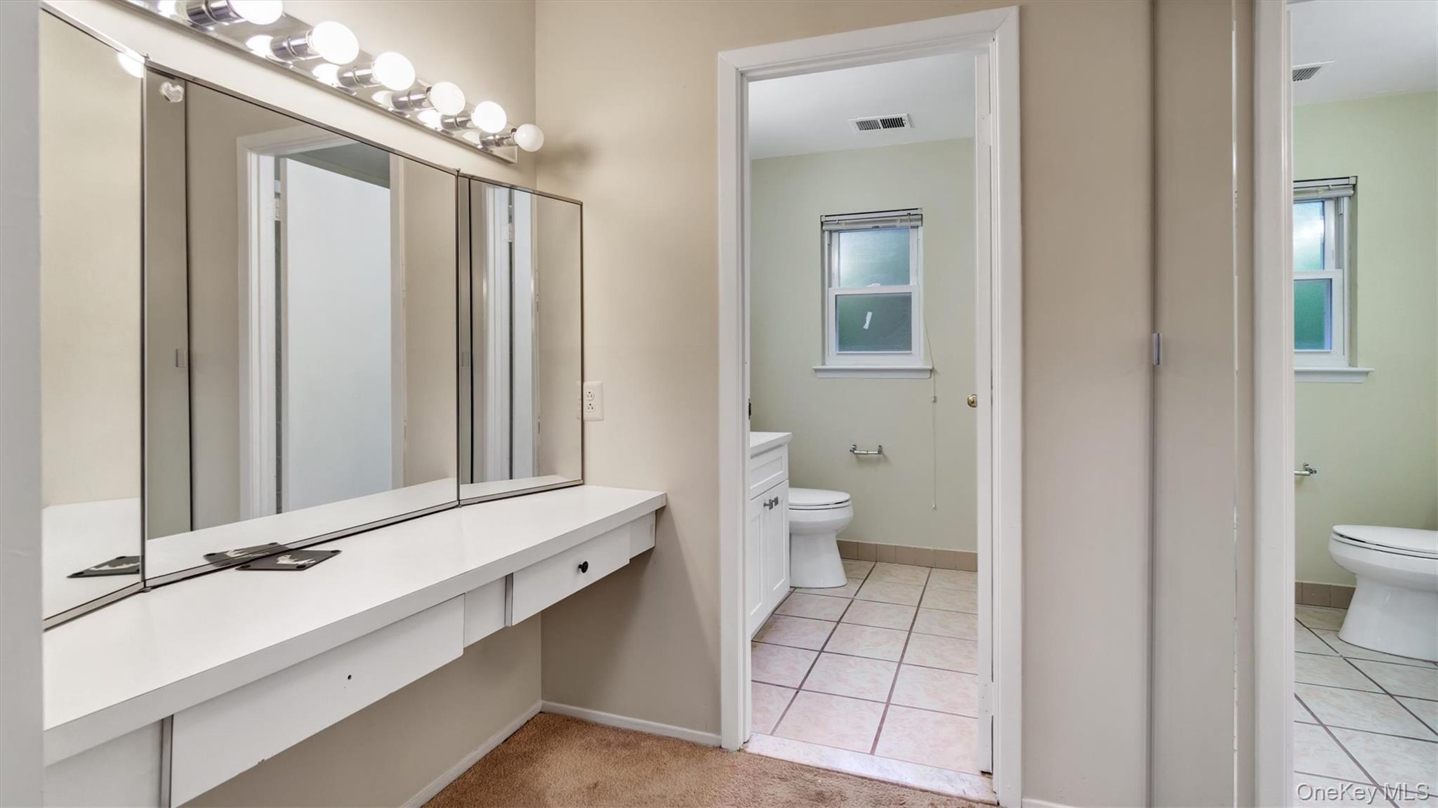 47 Carriage Road Roslyn, NY 11576 - Photo 20 of 31 Bathroom with toilet, visible vents, tile patterned flooring, and baseboards