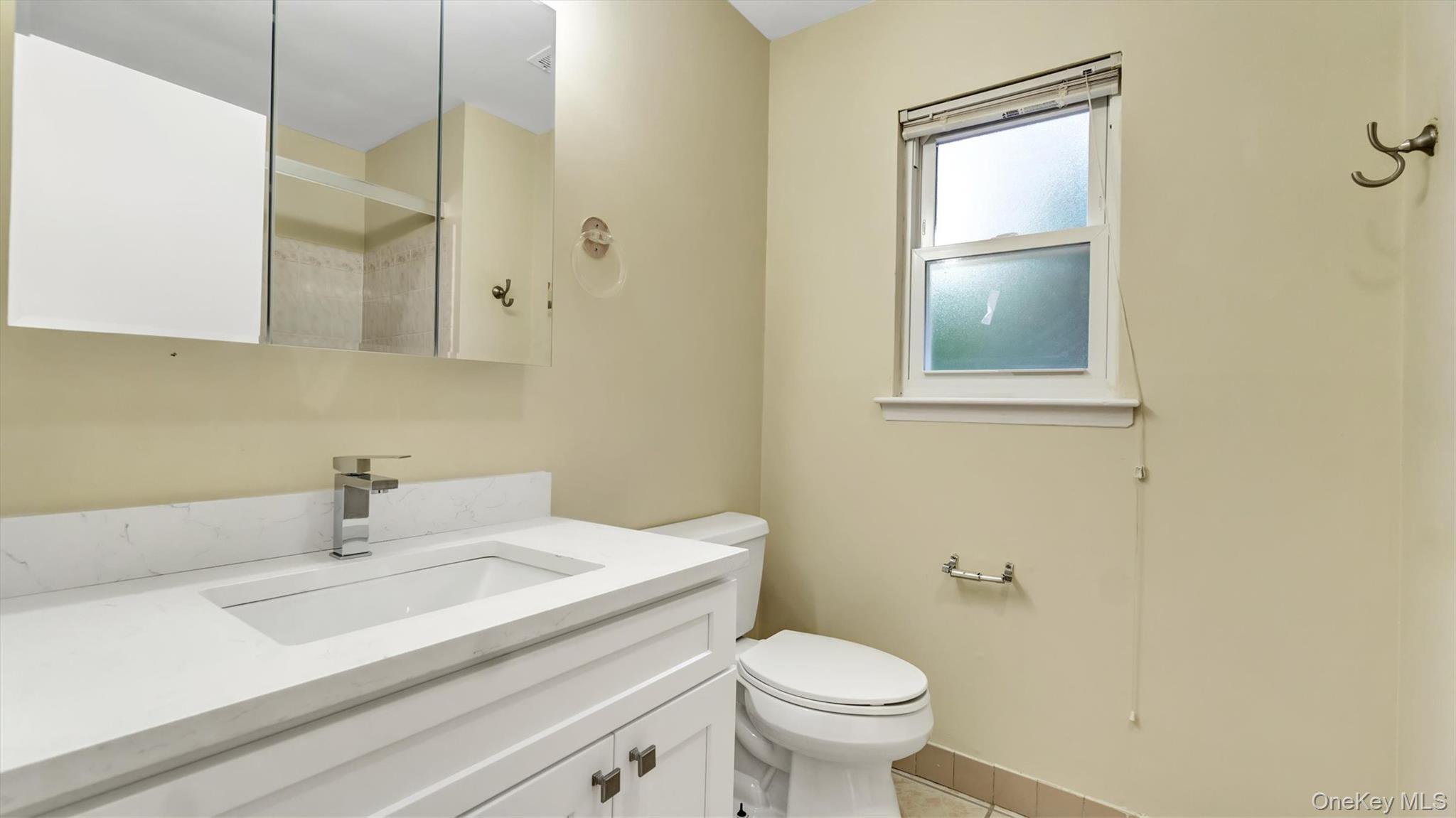 47 Carriage Road Roslyn, NY 11576 - Photo 21 of 31 Bathroom with vanity, toilet, a shower, and tile patterned floors