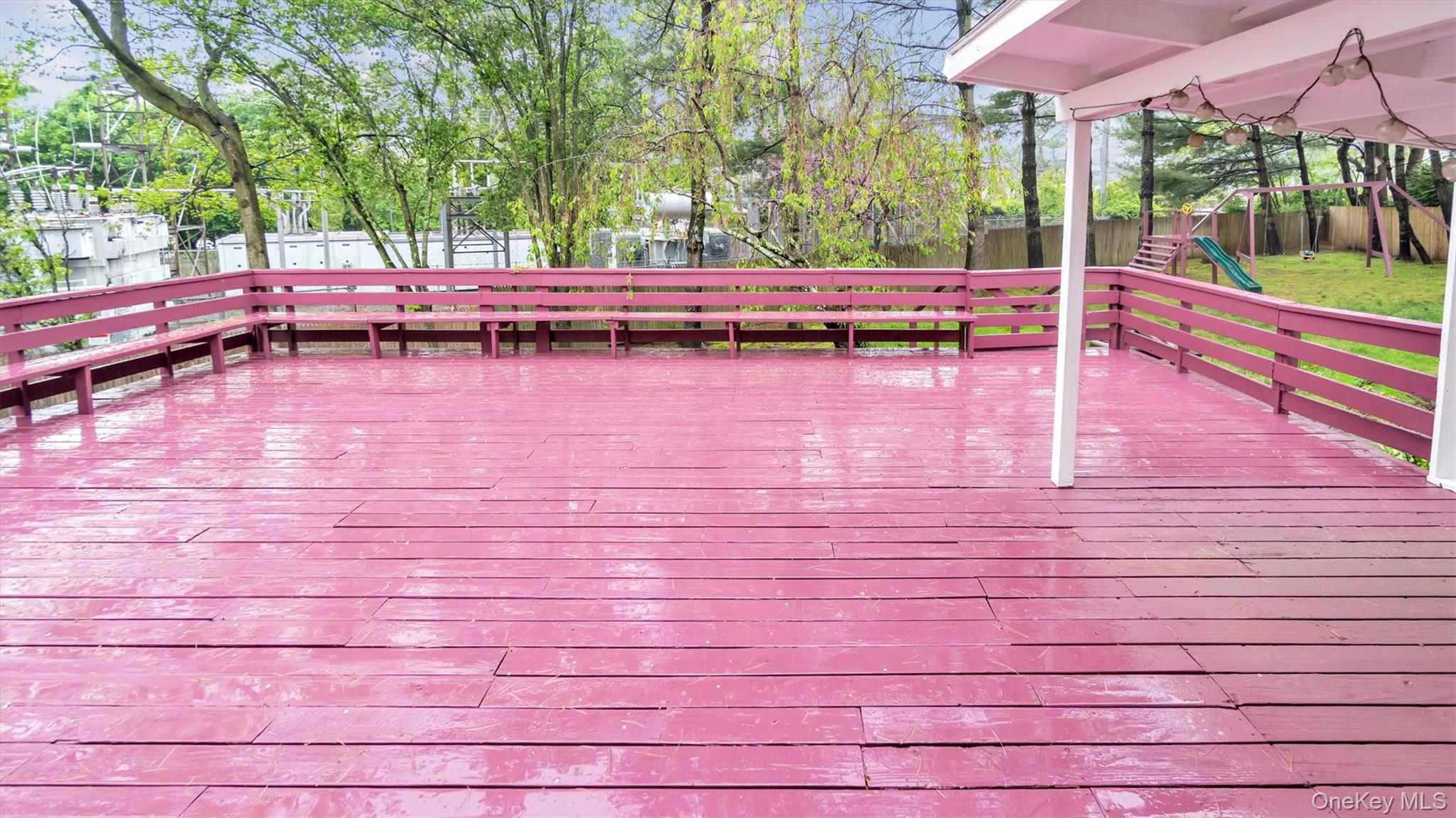 47 Carriage Road Roslyn, NY 11576 - Photo 27 of 31 Wooden deck with playground community and a fenced backyard