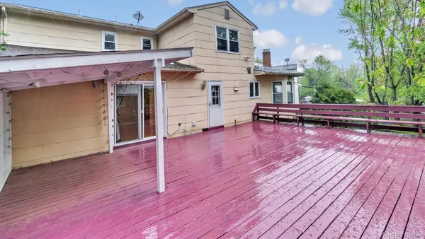 a view of a house with a backyard and a slide